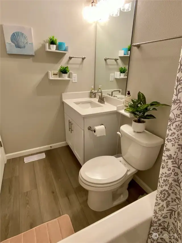 Full bath with LVP flooring and quartz counters