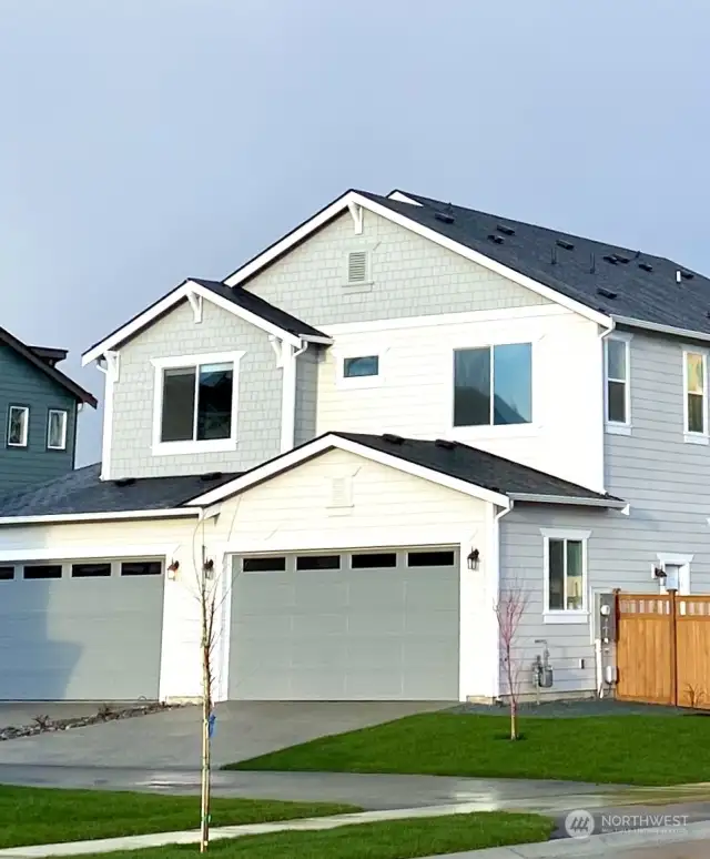 Two car garage with plenty of room for parking in the drive way.