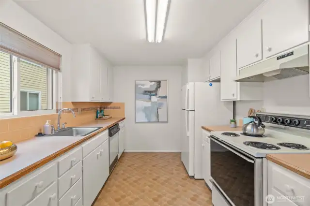Spacious kitchen with loads of counter space and storage.