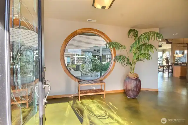 Entry looking into courtyard through large round window.