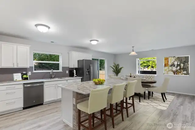 Virtually staged to show the space at the island and possibilities for the dining room
