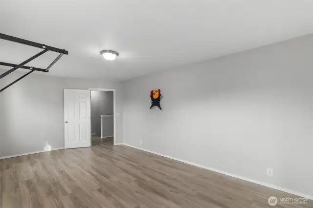 Another angle of the bonus room with newer LVP flooring for ease of care and durability. What will you use it for?
