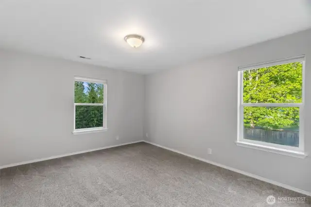 Bedroom number three has two windows and is located at the back of the house, overlooking the rear yard.