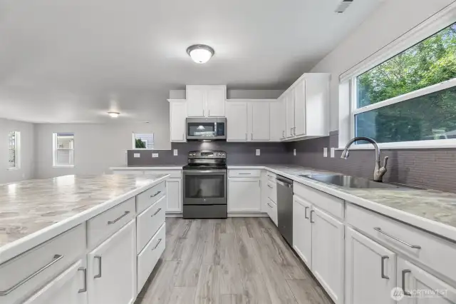 Huge kitchen island is a terrific gathering spot for entertaining, homework or casual dining.