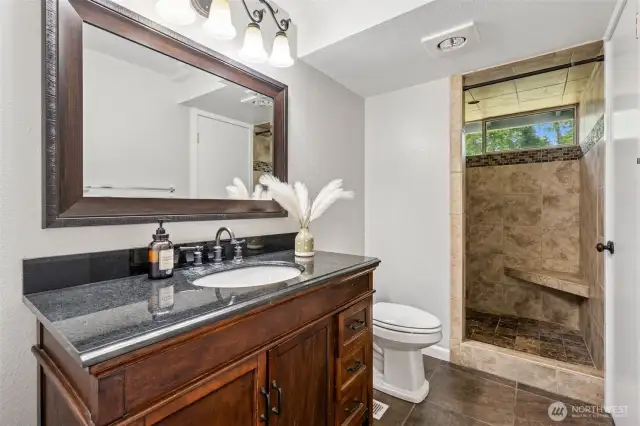 fully updated bath with tile suround.
