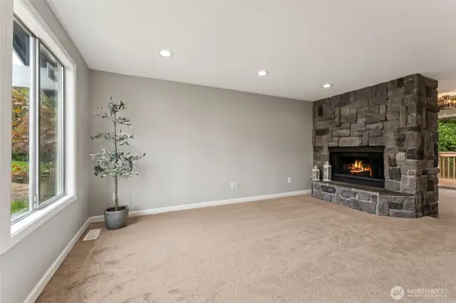 upstairs living room with a cozy wood fireplace.