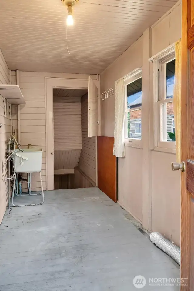 The space just off the kitchen that leads to the basement and backyard.