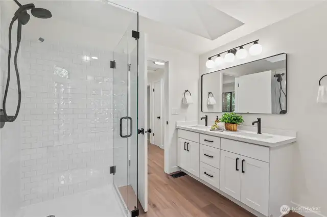 Shower and double vanity, in addition to soaking tub in main floor guest bath.