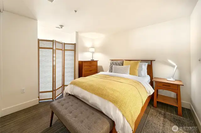 Bedroom -shown with a queen bed- is spacious and private.