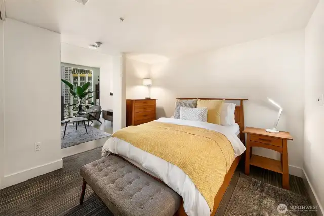 Bedroom -shown with a queen bed- is spacious and private.