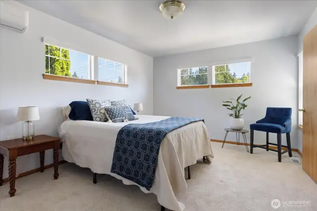 Primary bedroom with plenty of windows filling the room with natural light.
