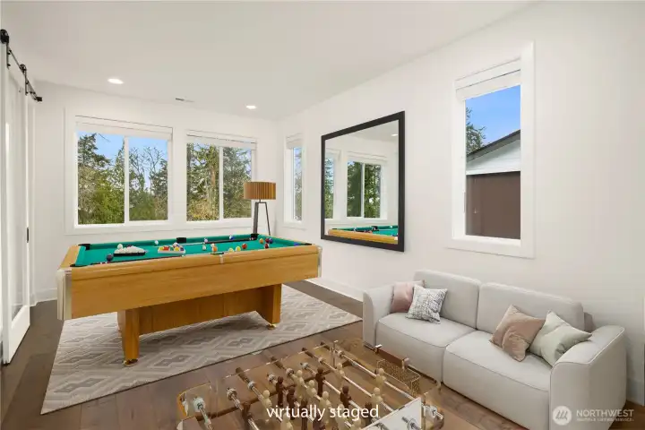 Virtually staged game room or bonus room adjacent to living room
