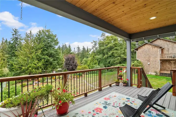 HUGE covered deck for year round enjoyment and entertaining. Relax and take in the lake view.