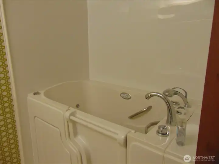 Walk-in Tub in the Primary Bathroom on the main level .