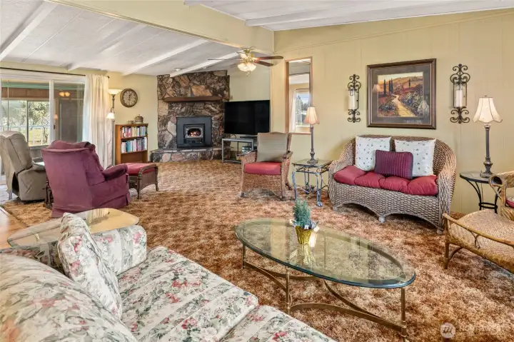 Open and spacious living room that looks into the family room with fireplace that has a wood insert!