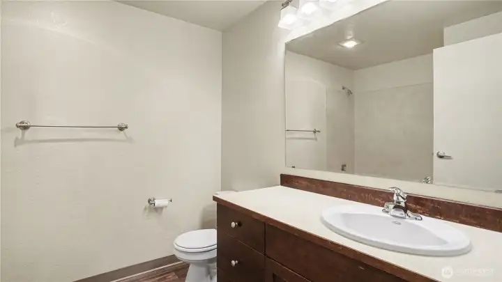 Primary bathroom with updated vanity offers an abundance of storage.