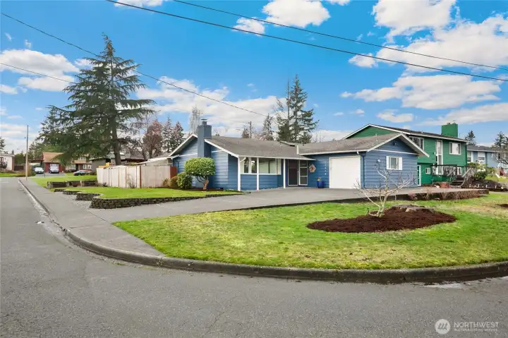 Desirable corner lot with landscaping.