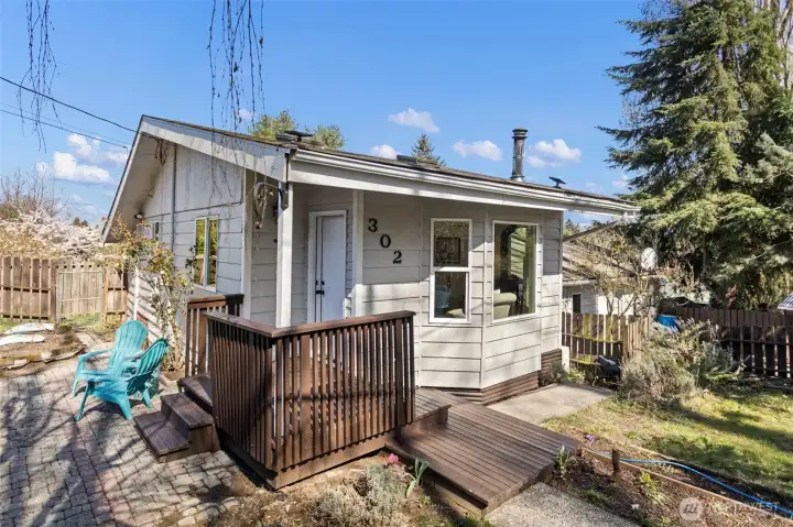 A 1915 South Park bungalow on a quiet corner. Covered entry porch, cobblestone path, and a wood stove flue that means business.