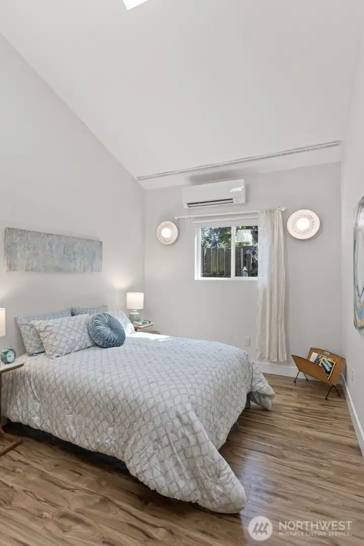 The skylight seals it — vaulted ceiling, natural light from above and through the south-facing window. This bedroom lives above its grade.