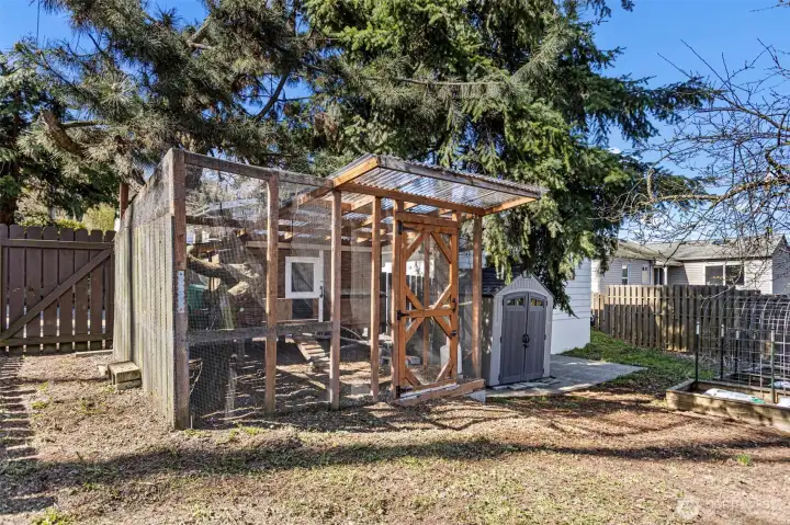 Gate, canoe, compost tumbler — the far end of a fully fenced 5,100 sq ft corner lot.