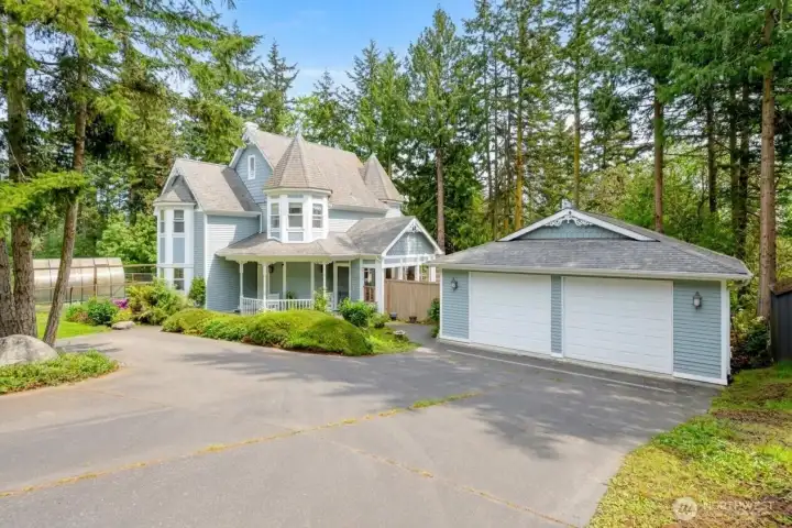 An impressive arrival begins with a long driveway, detached garage, and distinctive architecture surrounded by towering evergreens—privacy, character, and curb appeal in perfect harmony. An impressive arrival begins with a long driveway, detached garage, and distinctive architecture surrounded by towering evergreens—privacy, character, and curb appeal in perfect harmony.