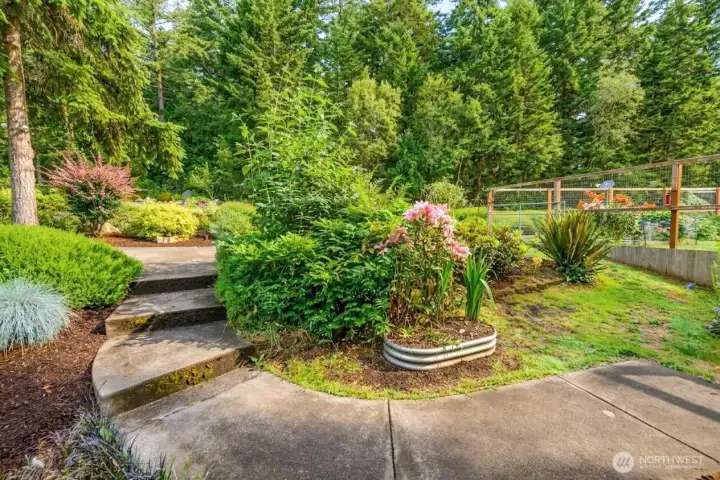 Lush gardens, winding pathways, and mature landscaping create a peaceful outdoor retreat where every season brings something beautiful to enjoy season after season. Lush gardens, winding pathways, and mature landscaping create a peaceful outdoor retreat where every season brings something beautiful to enjoy season after season.
