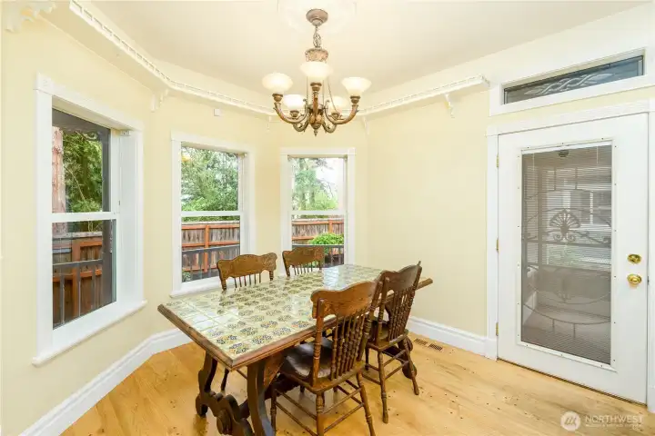 The dining area is accented by a flush mount light fixture and surrounded by windows and filled with natural light, this inviting dining nook is the perfect place to gather for everyday meals, celebrations, and meaningful conversation. The dining area is accented by a flush mount light fixture and surrounded by windows and filled with natural light, this inviting dining nook is the perfect place to gather for everyday meals, celebrations, and meaningful conversation.