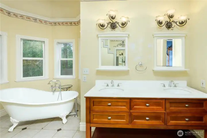 Indulge in a spa-inspired primary bath featuring a classic clawfoot soaking tub, dual-sink vanity, abundant storage, and timeless finishes designed for everyday timeless luxury. Indulge in a spa-inspired primary bath featuring a classic clawfoot soaking tub, dual-sink vanity, abundant storage, and timeless finishes designed for everyday timeless luxury.