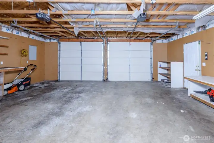 Spacious detached two-car garage with automatic openers, built-in shelving, workbenches, and ample room for vehicles, hobbies, storage, or a workshop. Spacious detached two-car garage with automatic openers, built-in shelving, workbenches, and ample room for vehicles, hobbies, storage, or a workshop.
