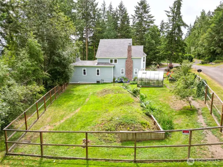 Luscious fenced gardens with hybrid 4 strain pear tree, strawberry beds, and greenhouse. Luscious fenced gardens with hybrid 4 strain pear tree, strawberry beds, and greenhouse.