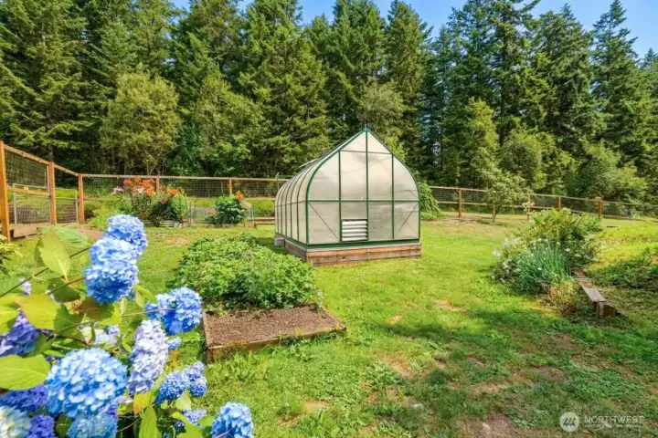Private retreat featuring distinctive Neo-Victorian architecture, mature evergreens, fenced grounds, greenhouse, detached two-car garage, and easy access to the nearby marina and waterfront. Property lines are approximate. Private retreat featuring distinctive Neo-Victorian architecture, mature evergreens, fenced grounds, greenhouse, detached two-car garage, and easy access to the nearby marina and waterfront. Property lines are approximate.
