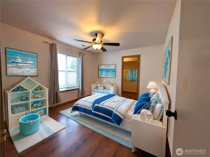 Bedroom 4 - lower level, features a large walk-in closet. Virtually staged to show versatility