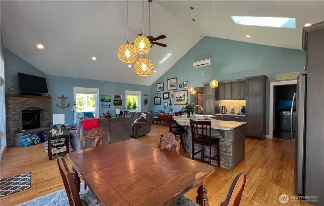 Another view of the great room, showing corner gas fireplace and side by side windows for added light along with the skylight.