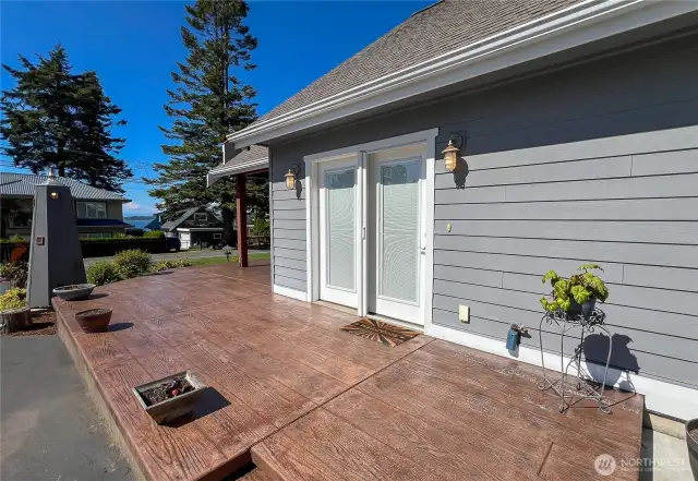 Main entrance off of driveway and wrap around patio.