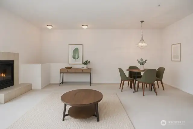Living room with fireplace opens up to dining area. Virtually Staged.