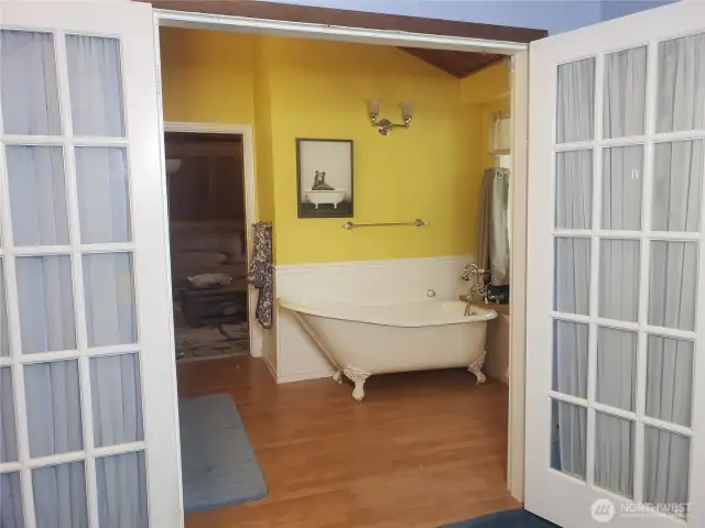 Primary 3/4 Bath with french doors, claw foot tub, double sinks an