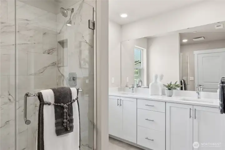 Serene primary bath designed with a double vanity and timeless finishes. Staged image from a different home of the same plan.