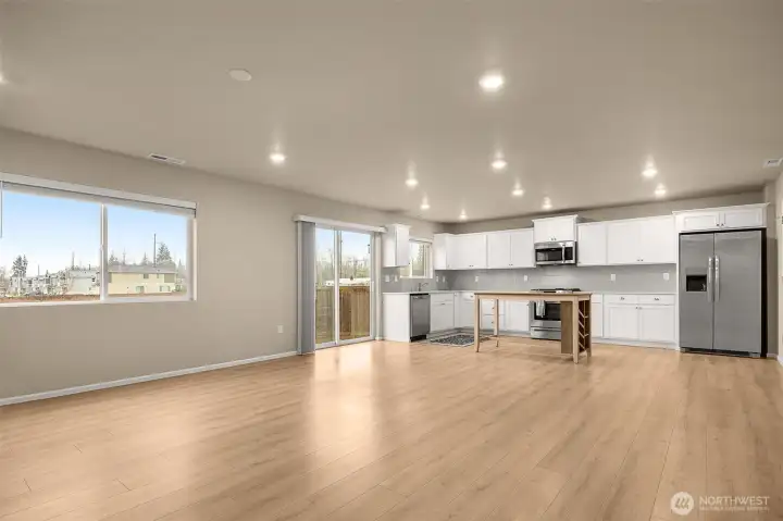 Open concept living space is open to living room and kitchen/dining space.