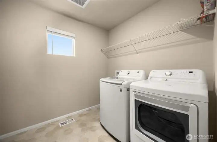 Laundry room has plenty of room for storage.