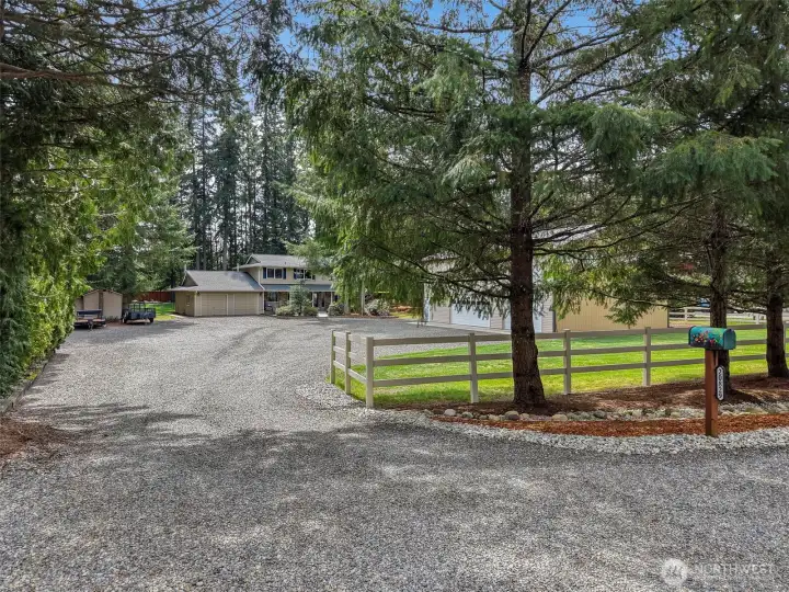 Nestled on a landscaped 1 acre lot this property offers privacy and convenience!  Bring all your recreational toys for there is TONS of parking.