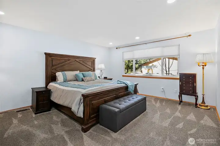 Primary bedroom is large with upgraded new carpet