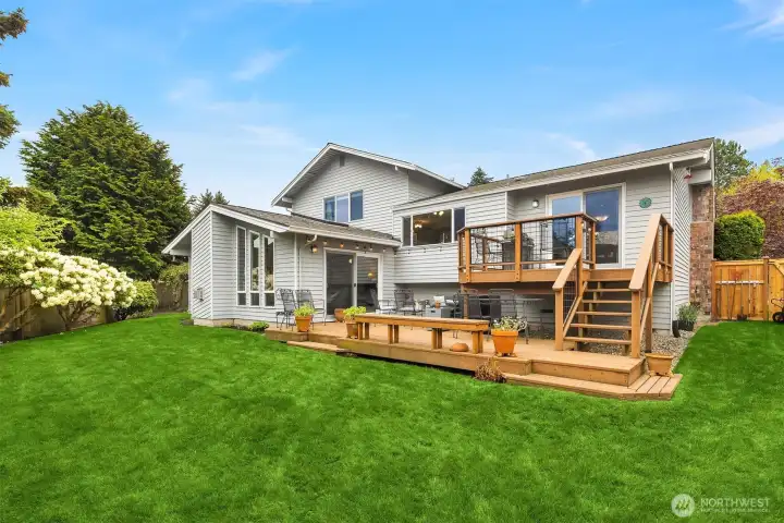 Gorgeous, fully fenced retreat of a backyard with a 2-level deck offering amazing opportunities for indoor-outdoor living
