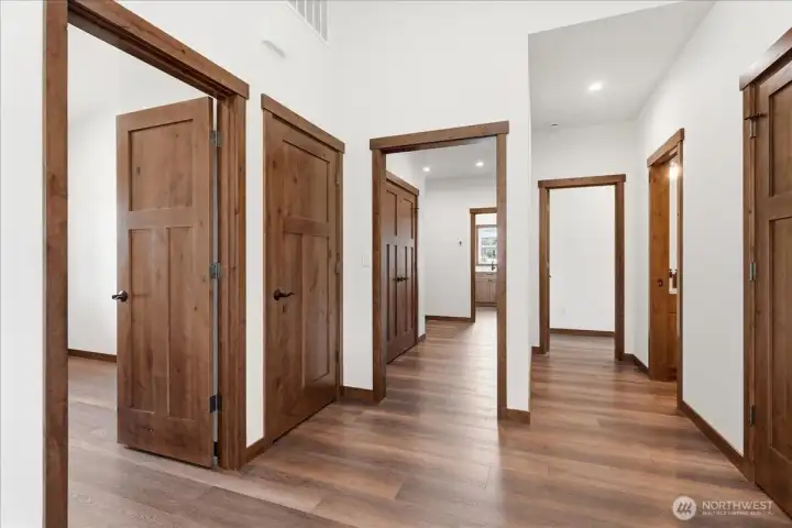 hallway to access office, laundry room, garage, powder room, and primary ensuite bedroom