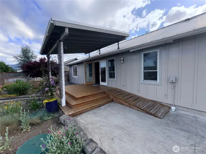 Back porch with a ramp leading down to gardens