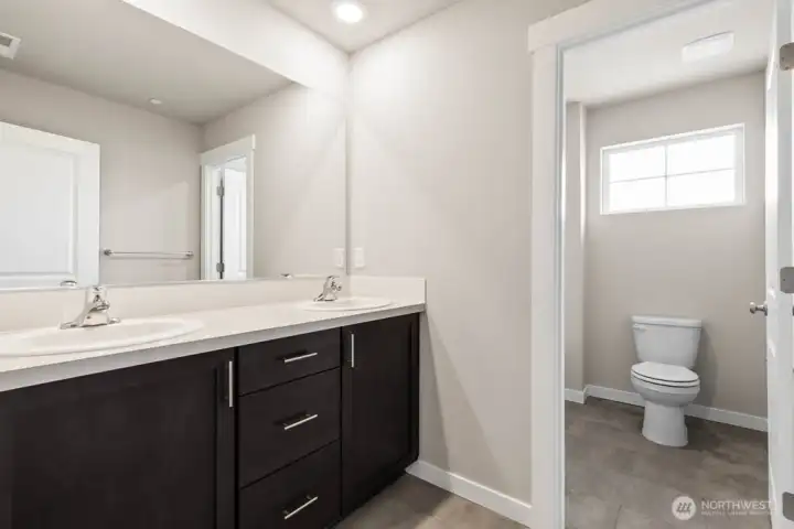 Bakerview Huntington Primary bath has light gray painted cabinetry and undermount sinks. Other finishes will vary.