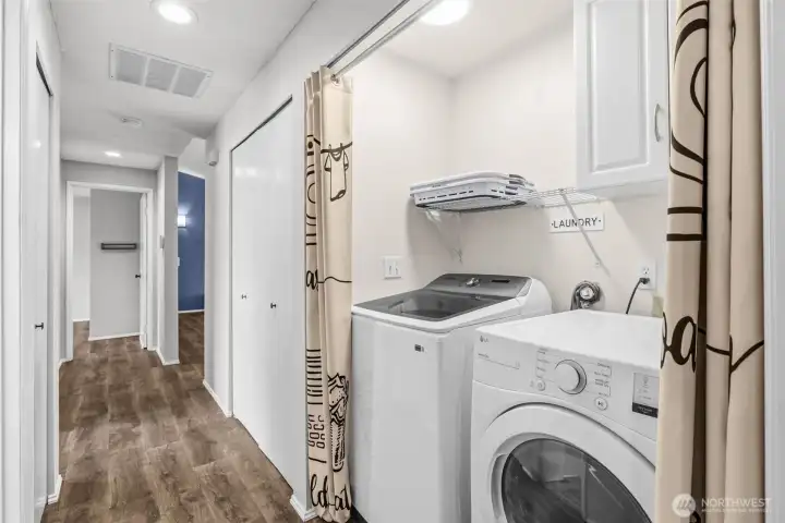 Laundry room with newer washer/dryer; everything stays.