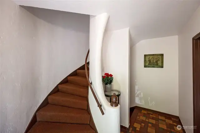 The curved stairways and tiled floors add design elements that are inviting and earthy.