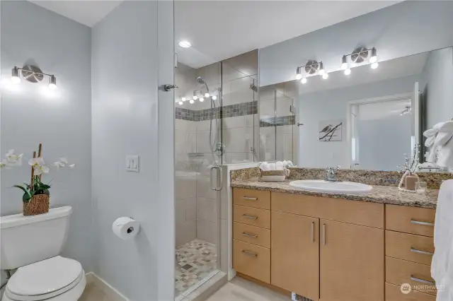 Renovated primary ensuite bath. No shortage of light fixtures throughout this stunning condo.