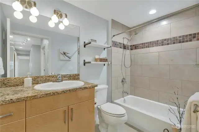 Renovated Full guest bath with slab granite.