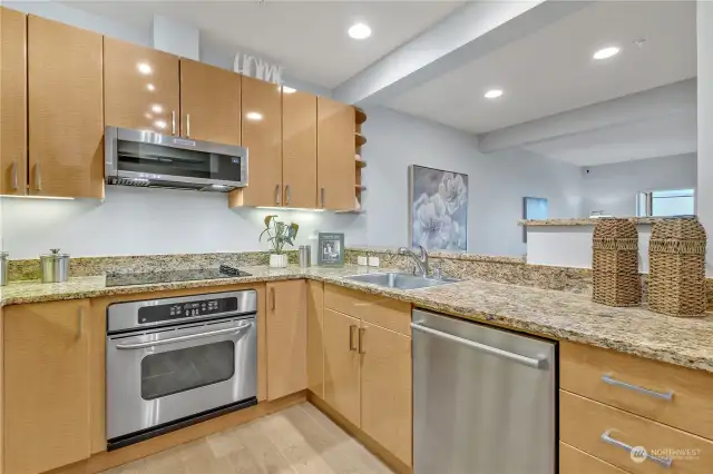 Beautiful gleaming cabinetry, slab granite, and under-cabinet lighting. Stainless steel appliances all stay.